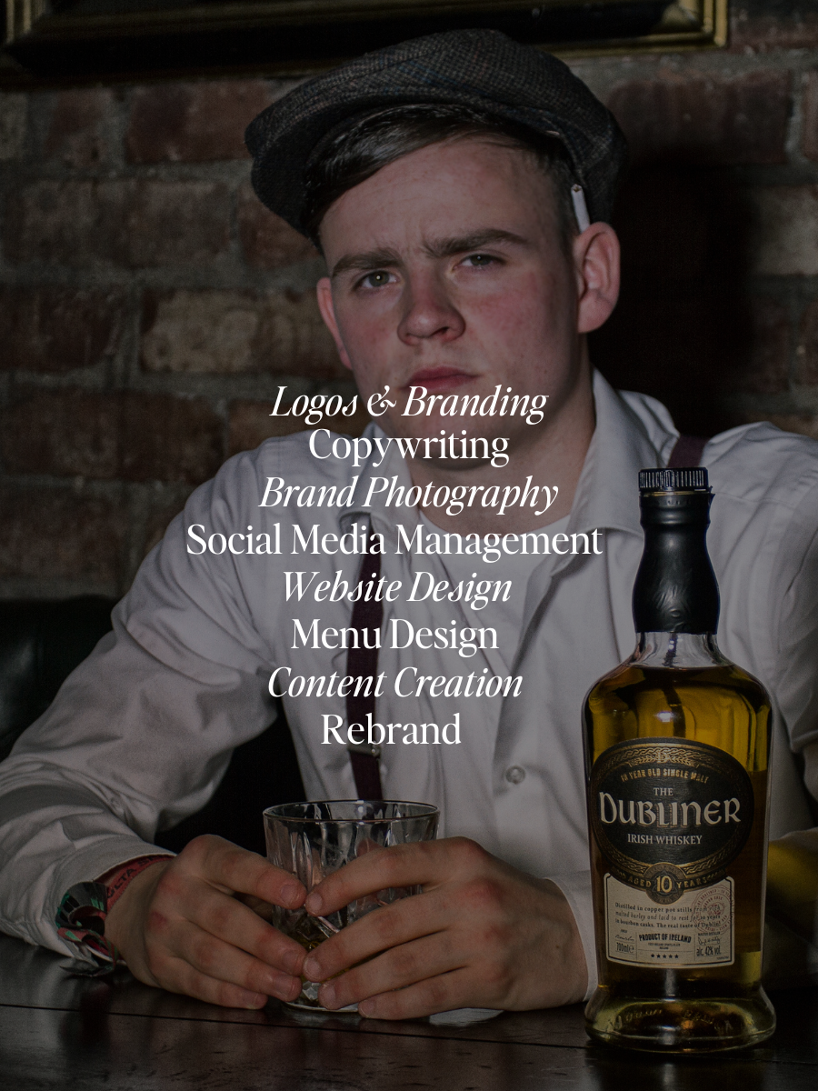 Image of boy with grandad cap and Dubliner whiskey in background, test says logo & branding, copywriting, brand photography, social media management, website design, menu design, content creation, rebrand
