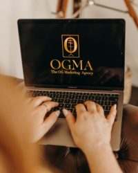 OGMA The OG Marketing Agency Logo on a laptop screen