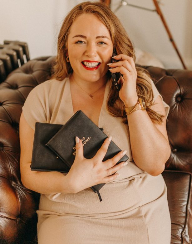 Digital Marketing Consultant & SEO Specialist Aoibhinn Cullen from The OG Marketing Agency talks about marketing strategy on her phone with books in her hand