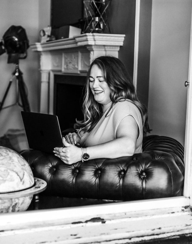 Digital Marketing Consultant & SEO Specialist Aoibhinn Cullen from The OG Marketing Agency works on her laptop creating a content marketing strategy